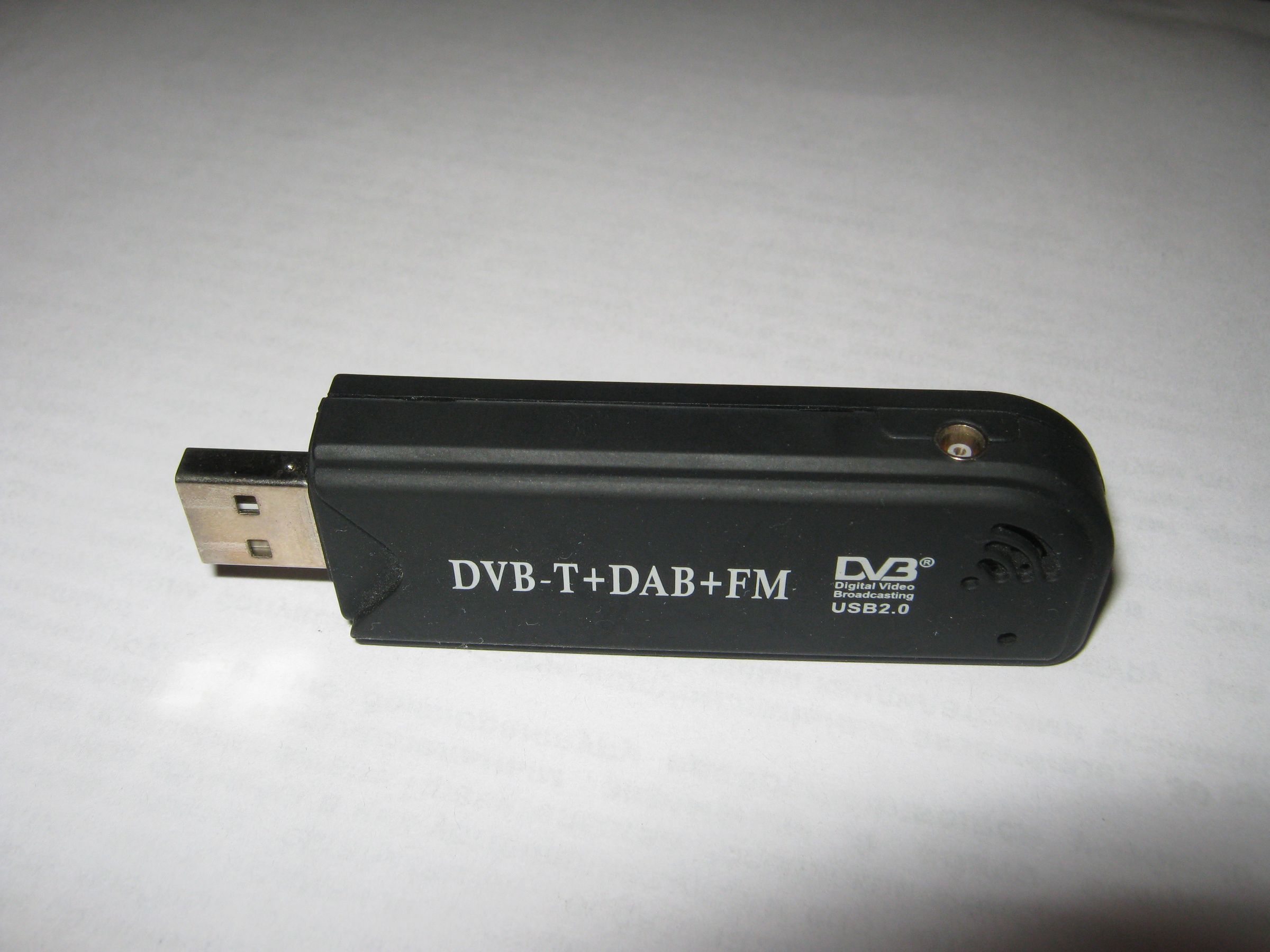 A black DVB-T USB dongle built on the Realtek RTL2832U chip, the low-cost software-defined radio used as the receiver in a home ADS-B station.