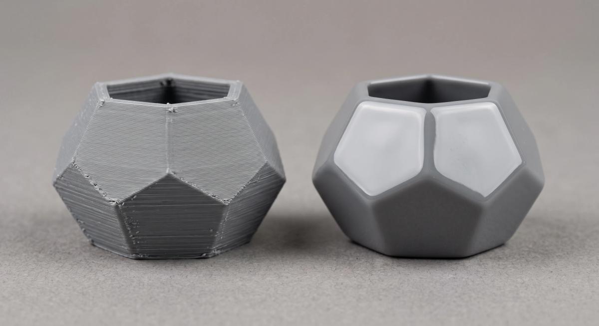 Two identical ABS prints side by side, one raw with layer lines and one glossy after acetone vapour smoothing