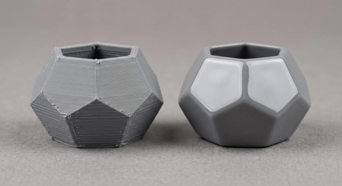 Two identical ABS prints side by side, one raw with layer lines and one glossy after acetone vapour smoothing
