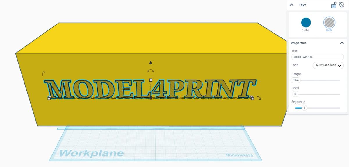 Text shape set to Hole in Tinkercad, positioned over a solid block before grouping