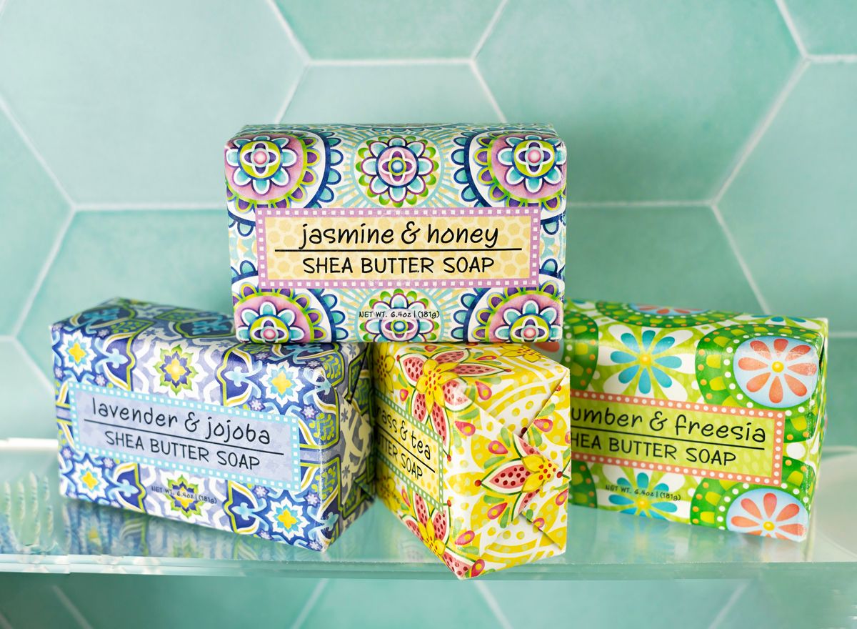 a variety of colorful soaps on a glass shelf as a product photo