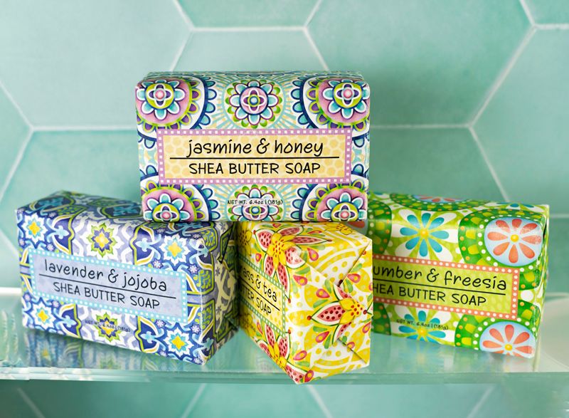 colorful soap on a clear shelf with a green tile background