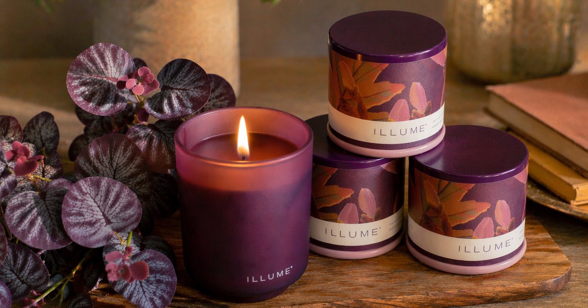 a group of soft maroon candles in a table scene for a product photo
