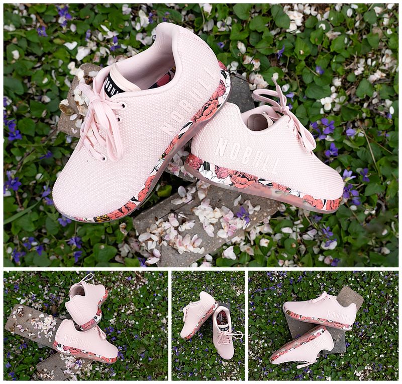 pink athletic shoe with floral soles on a bed of flowers