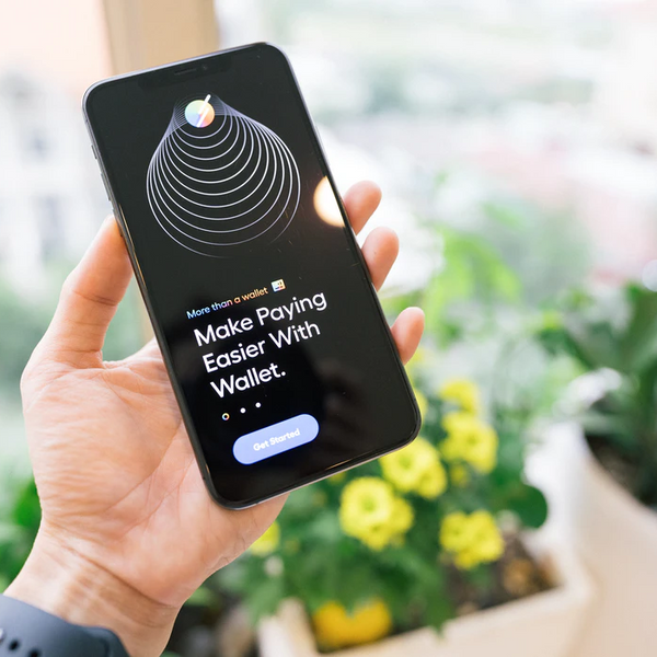 A person holding a phone showing an app