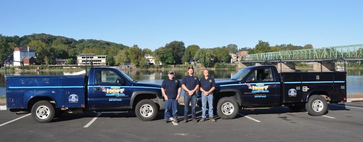 Jay Hoff and his son Caleb standing in front of the family work truck in Lambertville