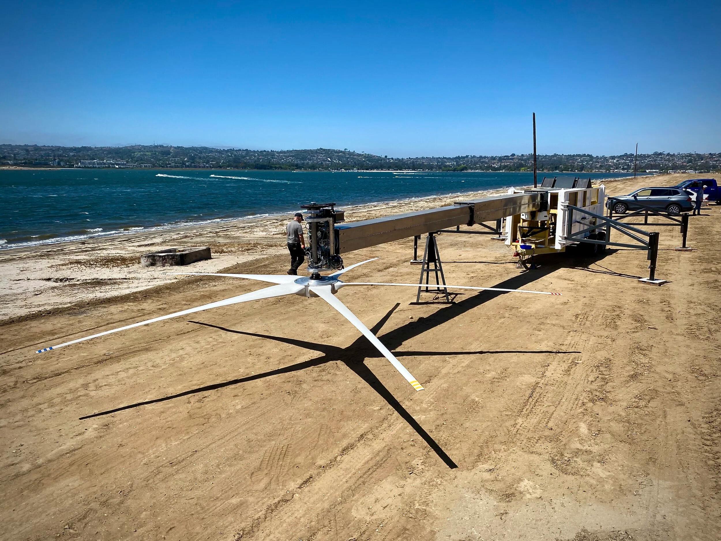 Outriggers deployed, mast extended, and blades attached; ready to hydraulically lift the mast and begin making power.