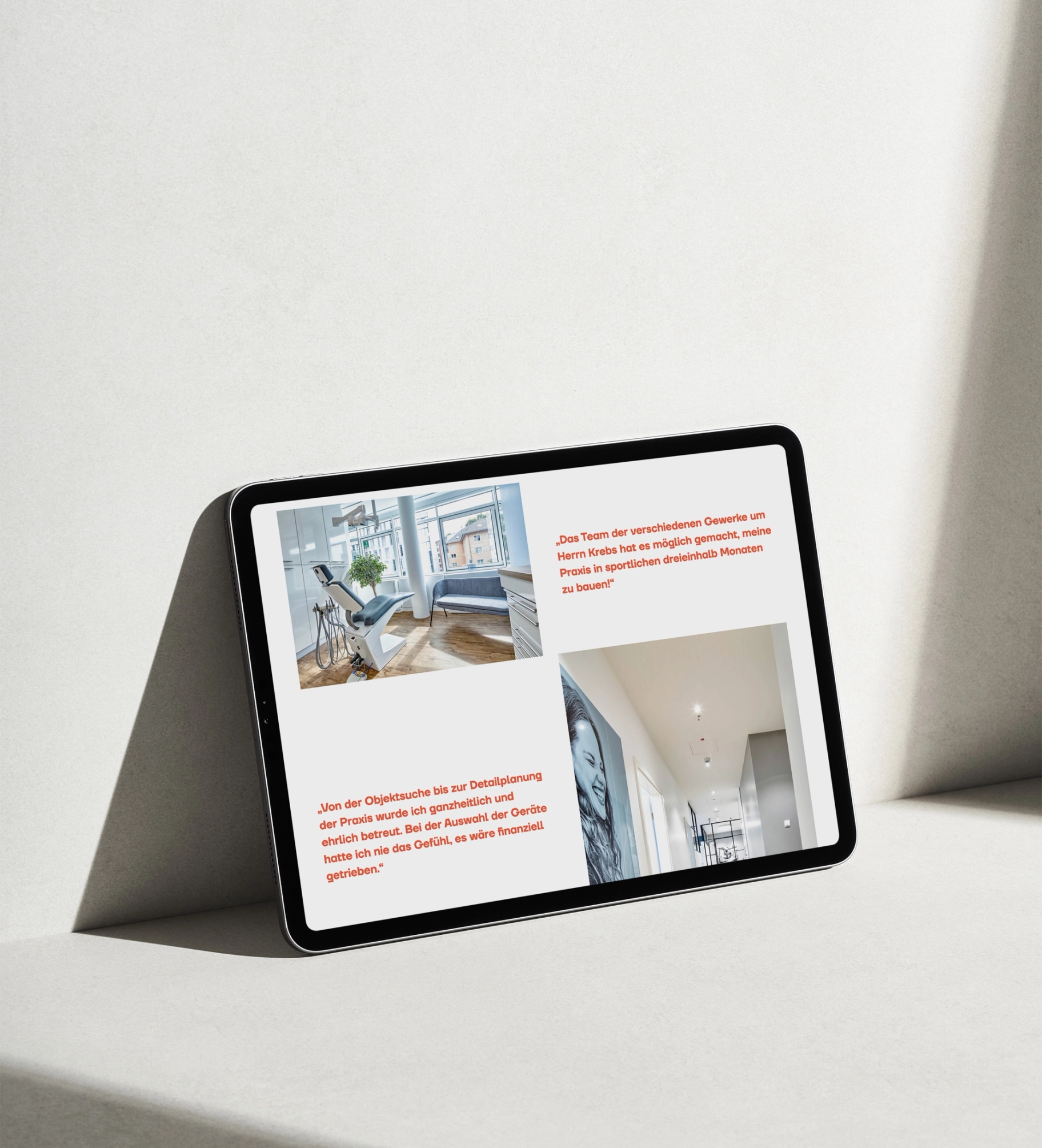 A tablet leaning against a white wall showing the Layout of the Website