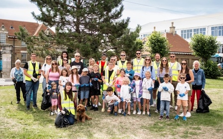 Families, children, and volunteers gather in East Cowes for NOSY’s Rubbish Networking clean-up, promoting community pride and environmental action.