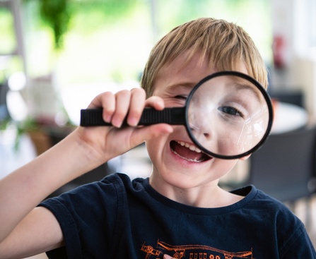 A child using a magnifying glass