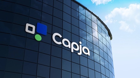 Capja logo displayed on a blue-glass office building with geometric icons in blue, green, and grey.