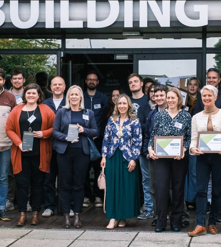 Group of people with their Green Impact 2023 awards outside of Building 41 in Cowes on the Isle of Wight