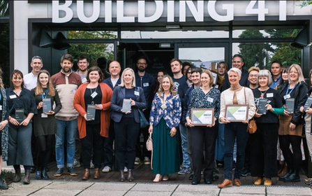 Group of people with their Green Impact 2023 awards outside of Building 41 in Cowes on the Isle of Wight