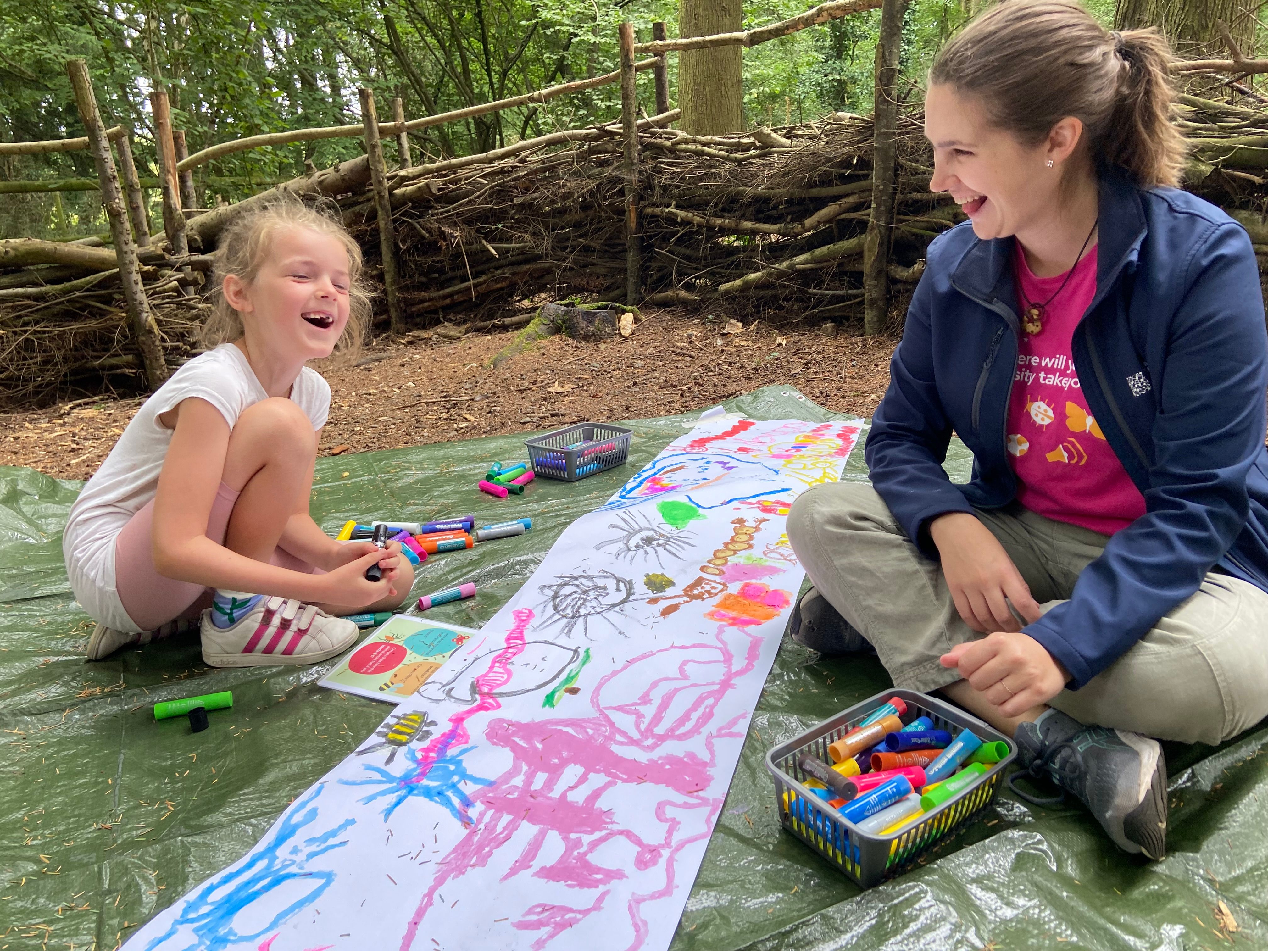 A Wonderseekers team member leading an activity in woodland.