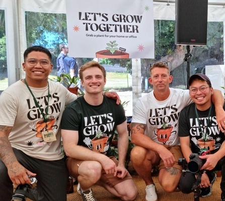 NOSY team posing in front of the “Let’s Grow Together” banner at the Isle of Wight Chamber Expo 2025