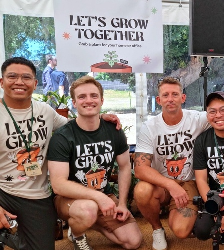 NOSY team posing in front of the “Let’s Grow Together” banner at the Isle of Wight Chamber Expo 2025