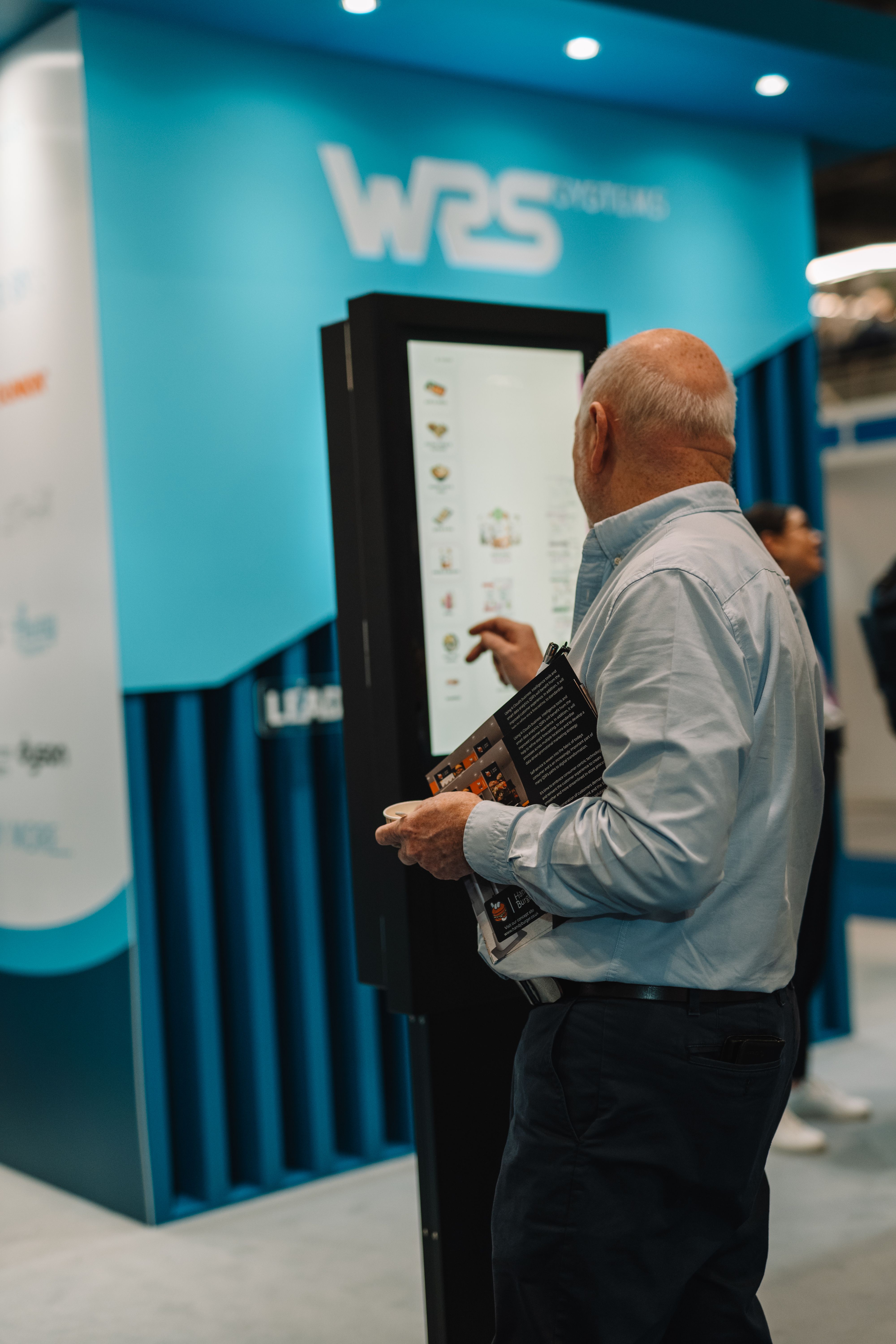 A person using a WRS Systems point of sale (POS) kiosk