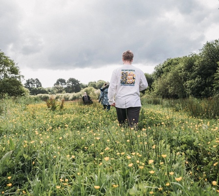 NOSY team walking through a wildflower field