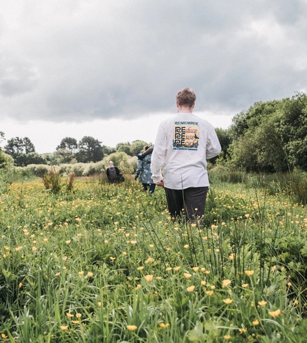 NOSY team walking through a wildflower field