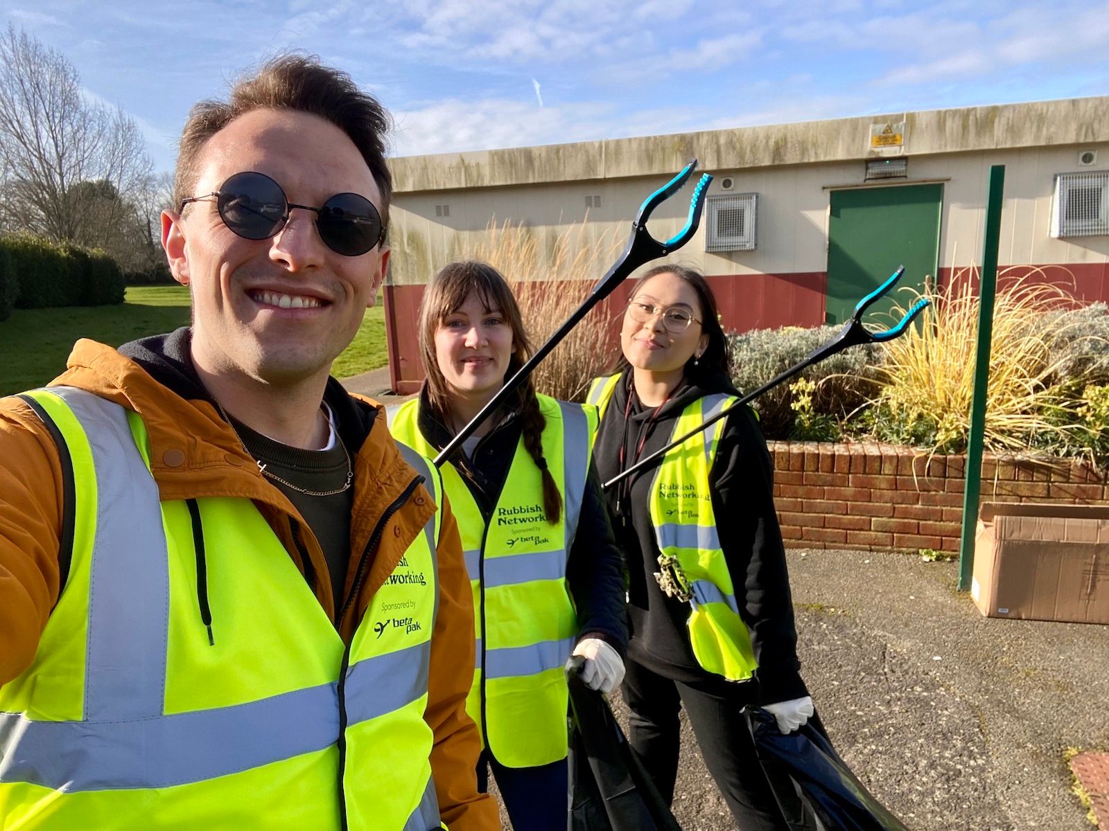 Henry, April and Georgina hold up litter pickers, ready for Rubbish Networking