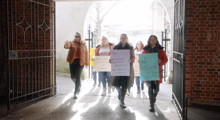 A group of women marching in protest of violence against women and girls
