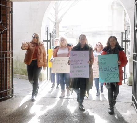 A group of women marching in protest of violence against women and girls