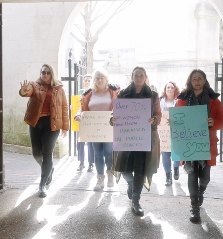 A group of women marching in protest of violence against women and girls
