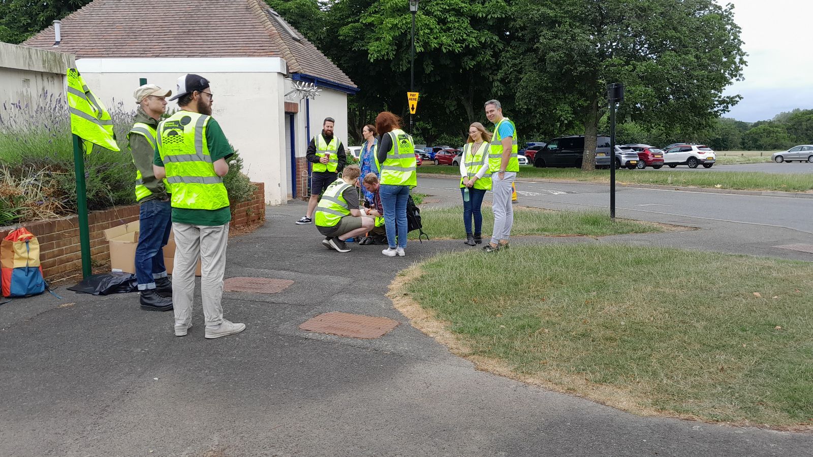 Attendees of Rubbish Network wearing high-vis and waiting to get started at Seaclose Park, Newport