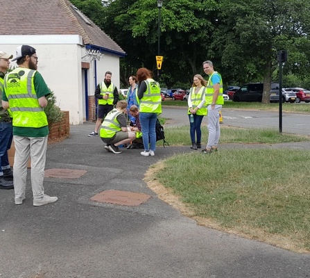 Attendees of Rubbish Network wearing high-vis and waiting to get started at Seaclose Park, Newport