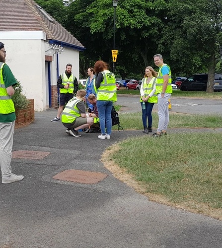 Attendees of Rubbish Network wearing high-vis and waiting to get started at Seaclose Park, Newport