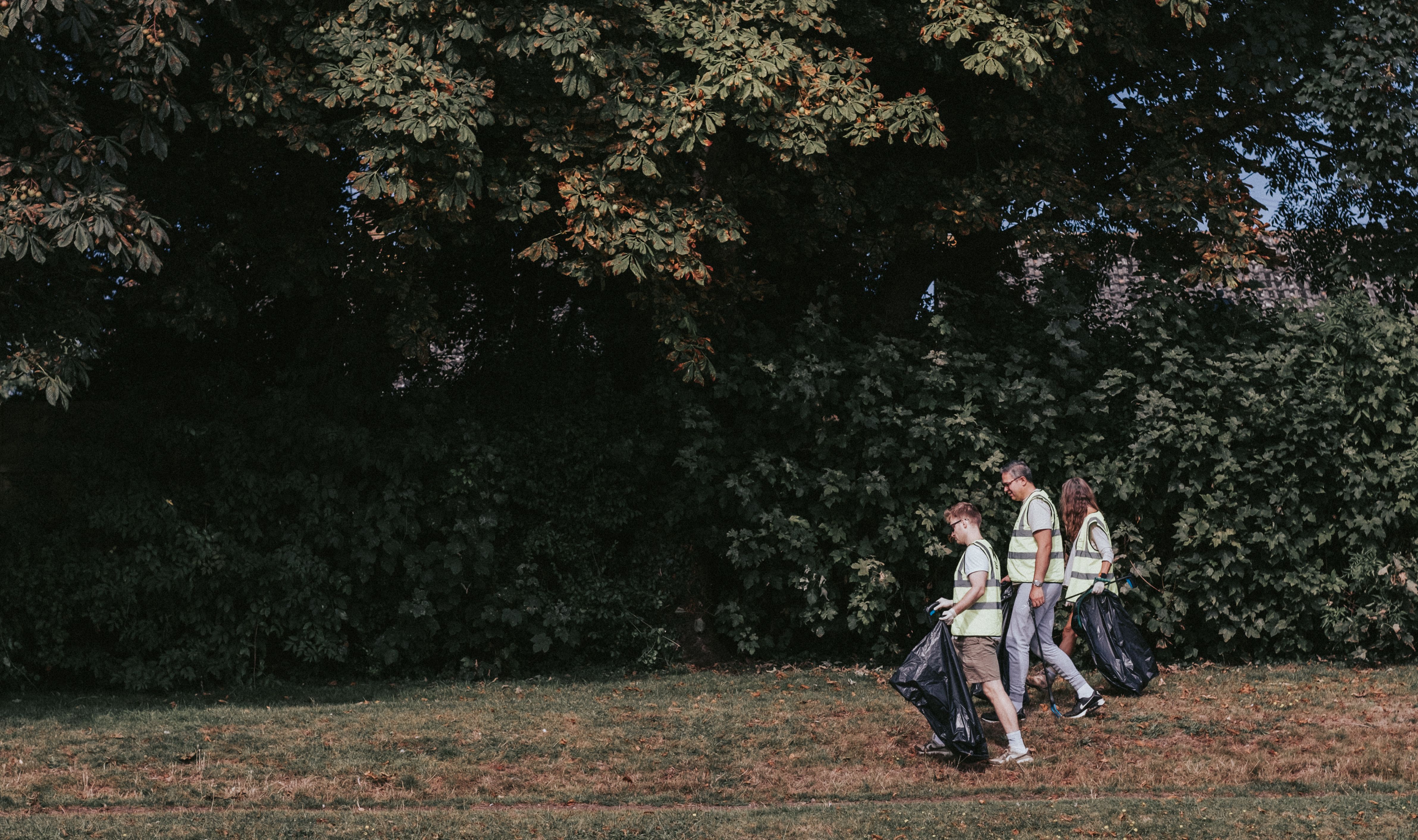 Matt Greg and Solene Pasquier of NOSY chat to Jonathan Thornton of PC Consultants while picking up litter in Victoria Recreation ground in Newport