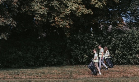 Matt Greg and Solene Pasquier of NOSY chat to Jonathan Thornton of PC Consultants while picking up litter in Victoria Recreation ground in Newport