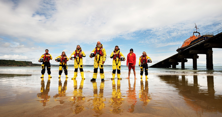 RNLI crew on a beach