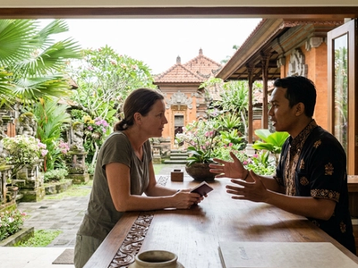 Can I check into a hotel in Bali without the person who booked it?