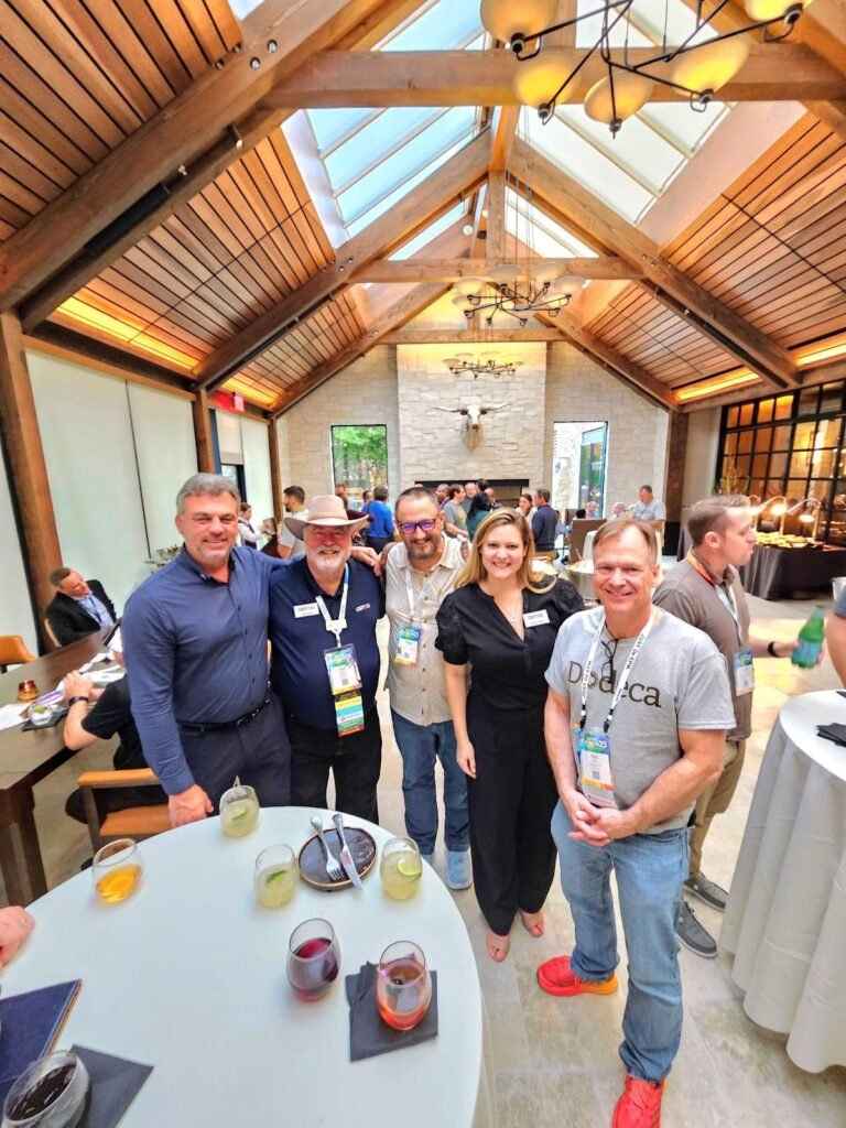 Kscope25 attendees gathered at a table during a conference event.
