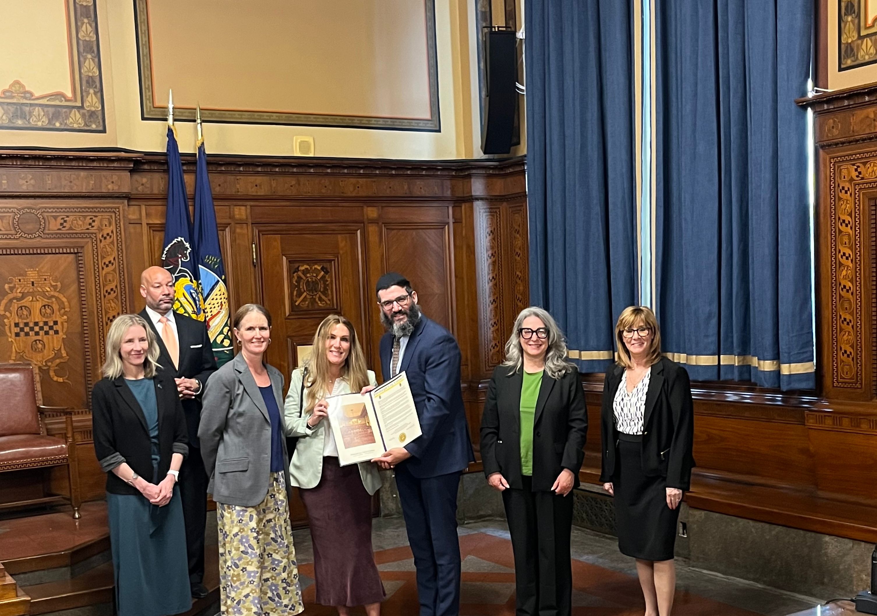 Rivkee and Rabbi Mordy with members of Pittsburgh City Council at City Hall pose for a photo with city proclamation for Friendship Circle