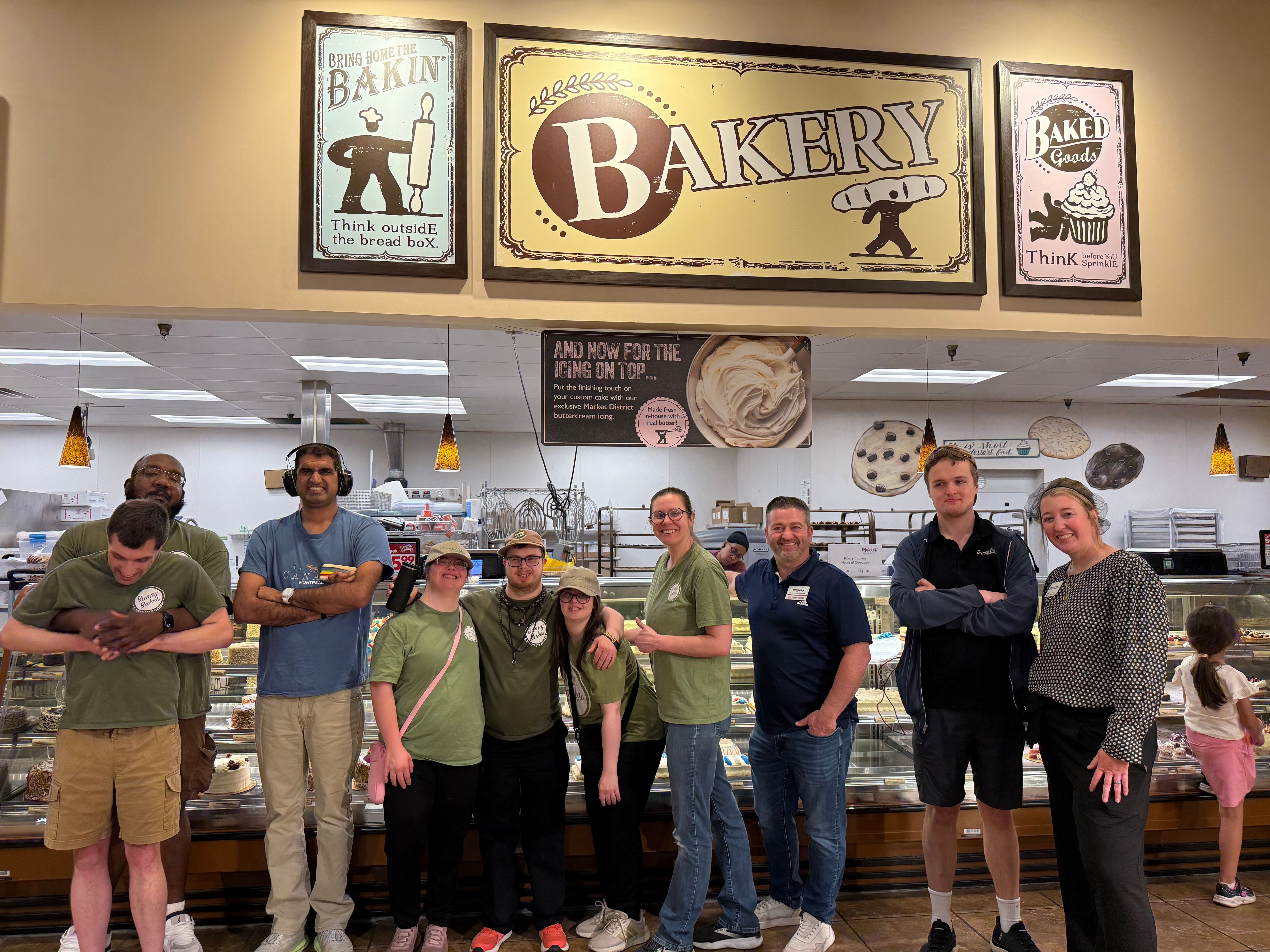 Bunny Bakes trainees and staff pose together inside the Giant Eagle bakery during a behind the scenes tour.