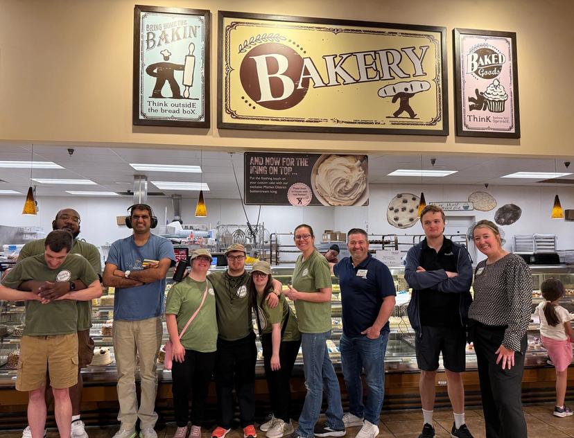 Bunny Bakes trainees and staff pose together inside the Giant Eagle bakery during a behind the scenes tour.