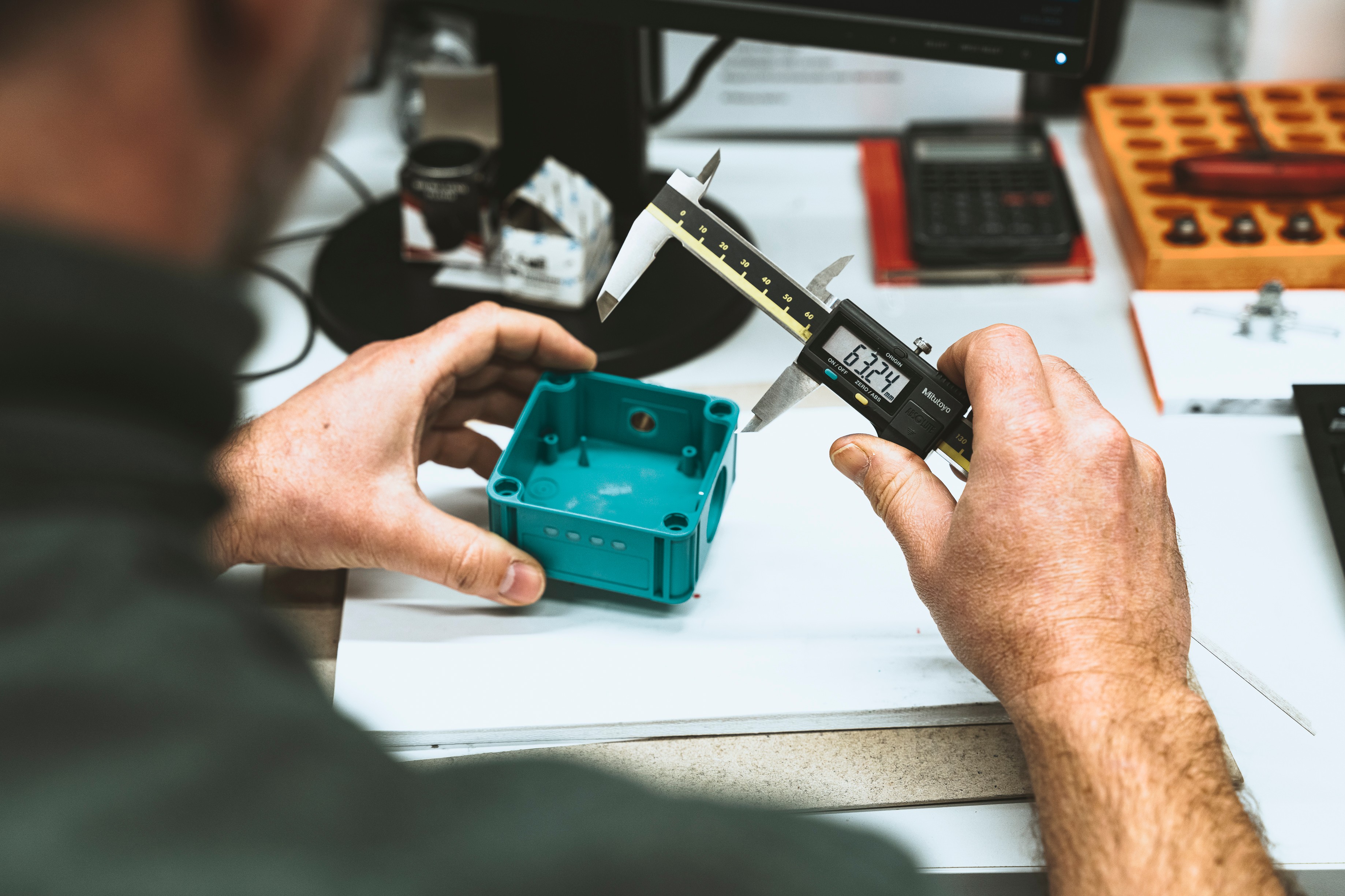 Caliper with plastic injection-molded part