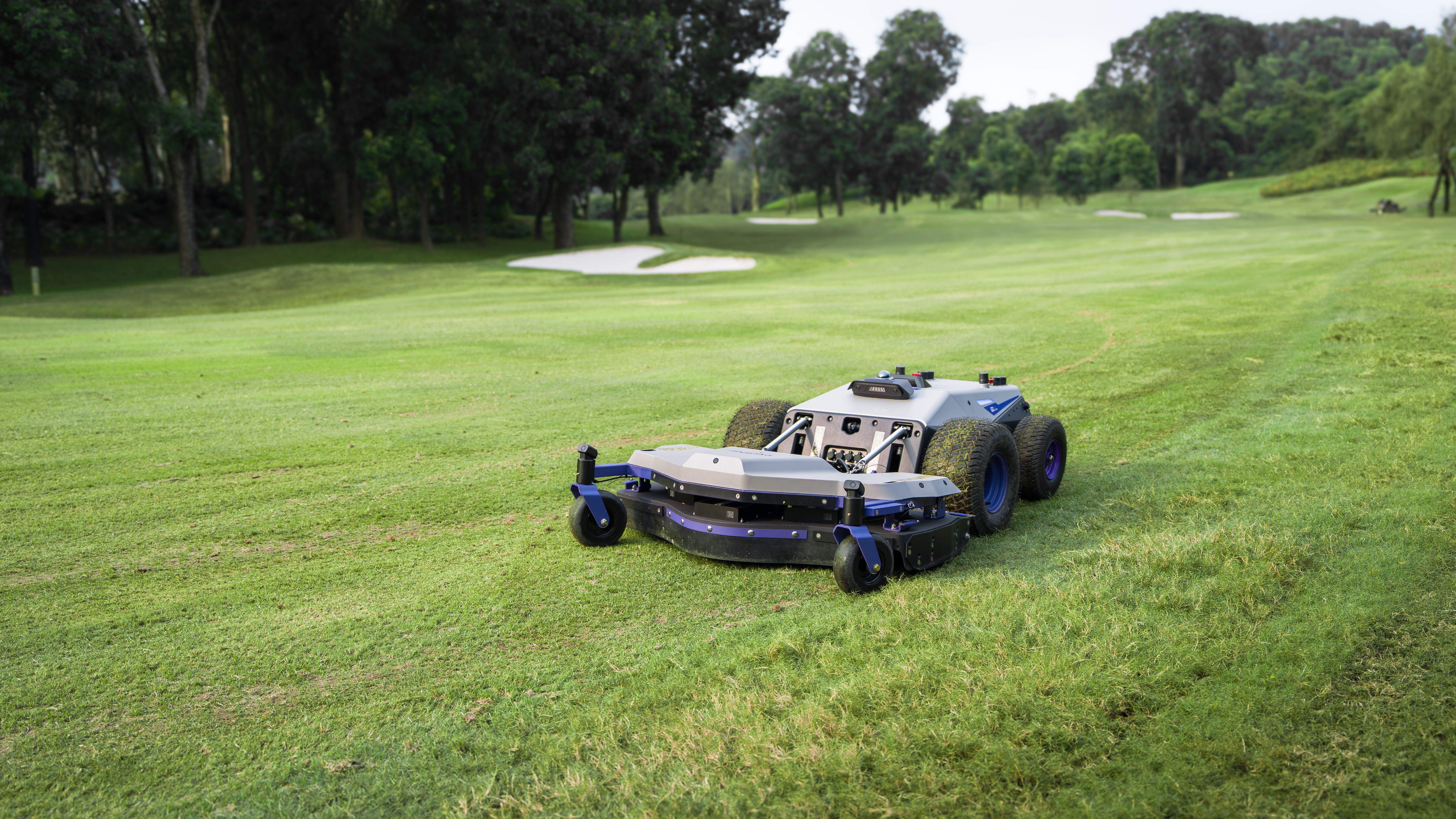 PANDAG G1 autonomous robotic mower operating on a golf course rough