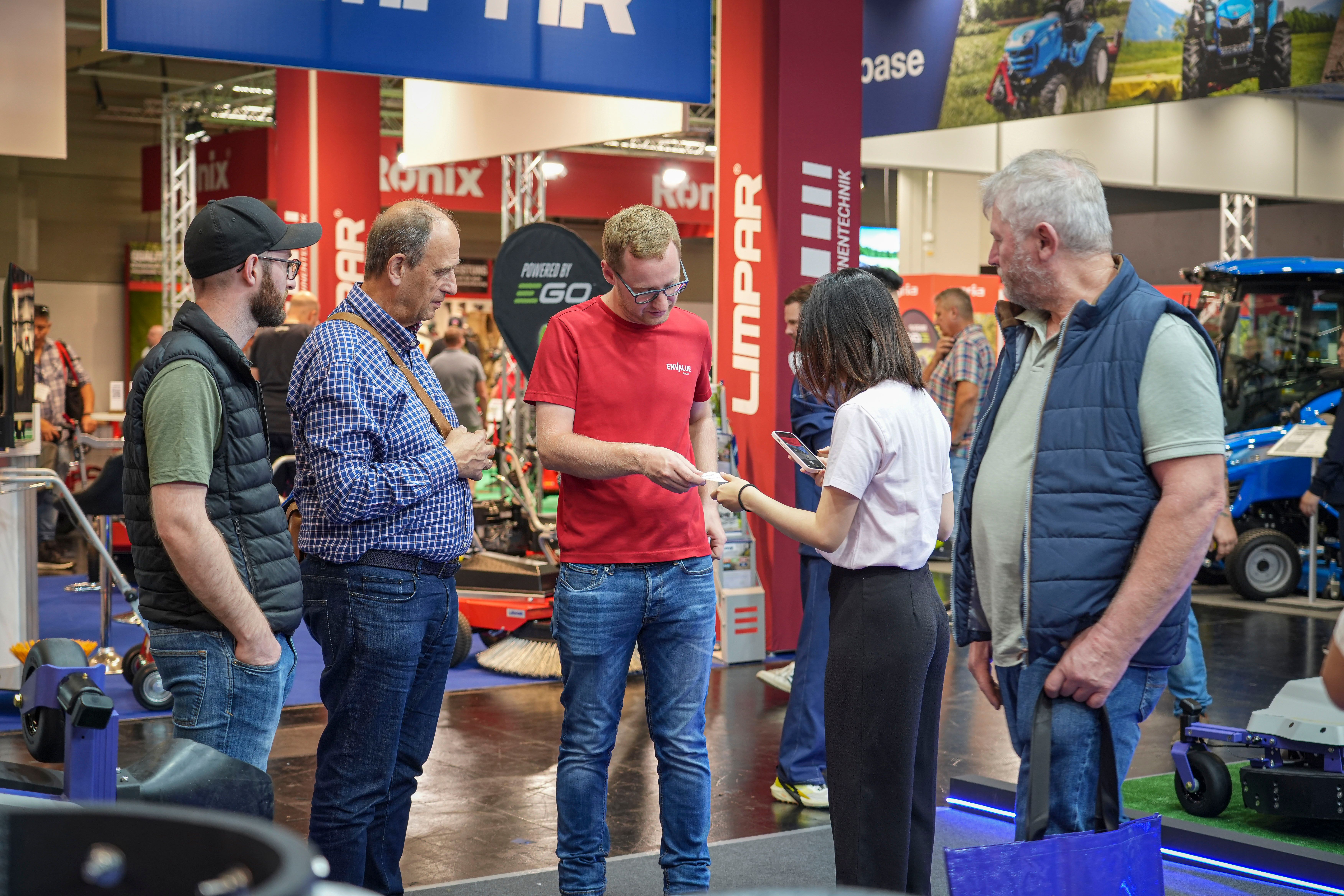 PANDAG team discussing G1 commercial robotic mower applications with a visitor