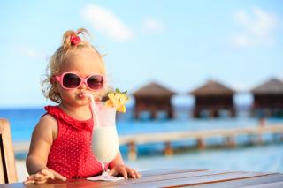 Toddler drinking a mocktail in the Maldives