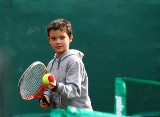 Child playing tennis