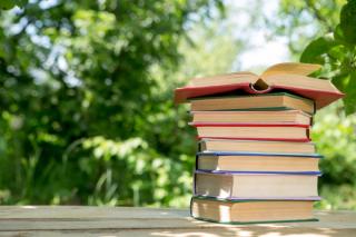 Pile of books on an outdoor table