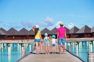 Family walking to an over-water villa