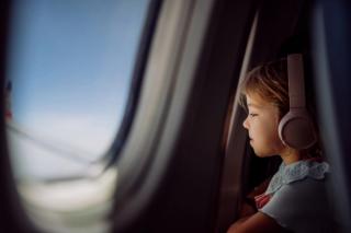 Child looking out of an aeroplane window