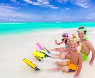 Children with fines, snorkels and masks