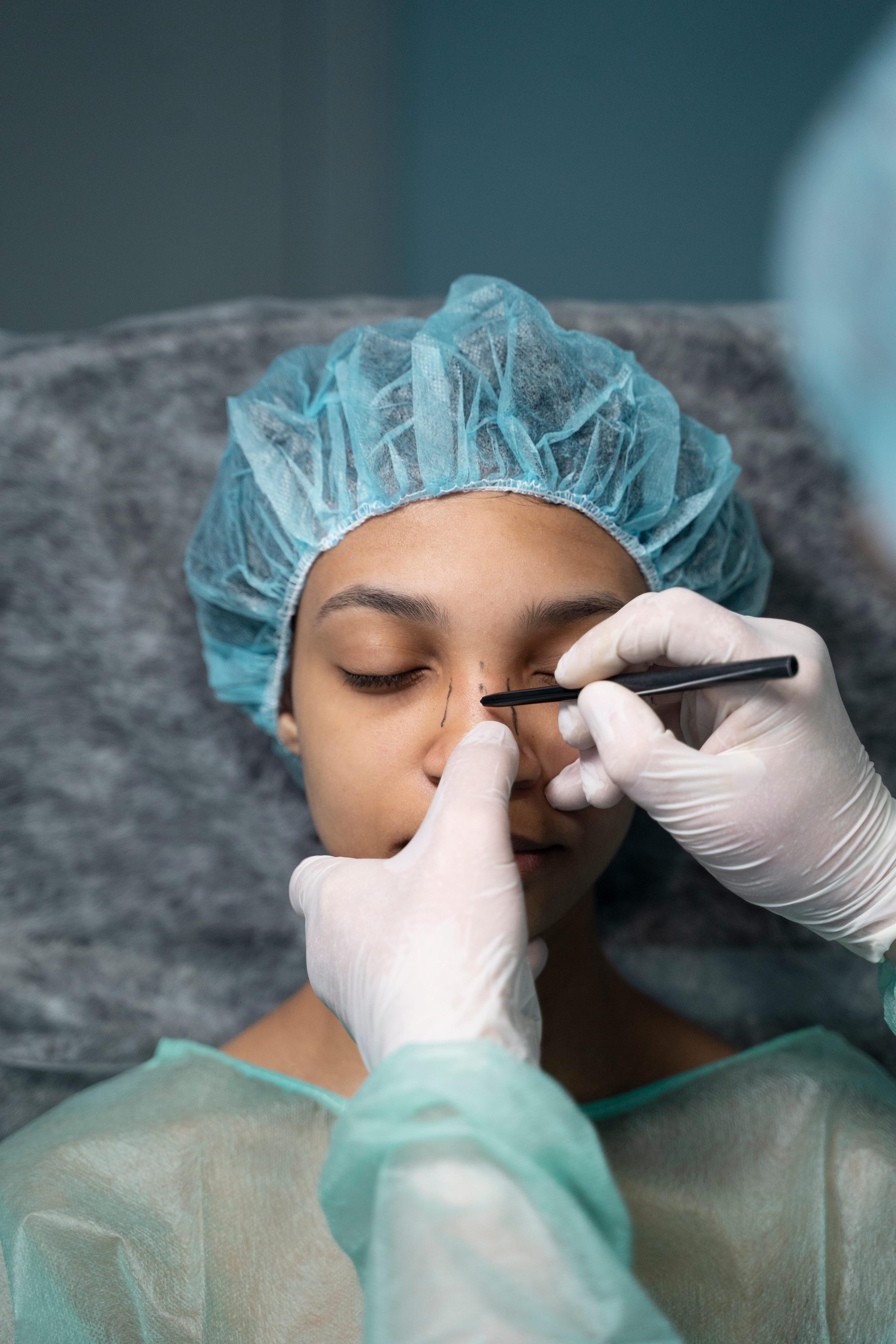 doctor examining the patient's nose before the operation