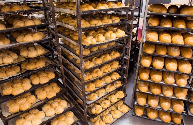 Racked trays of baked product in a commercial bakery