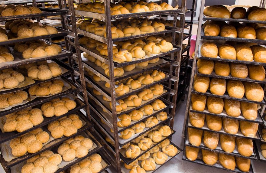 Racked trays of baked product at a commercial bakery